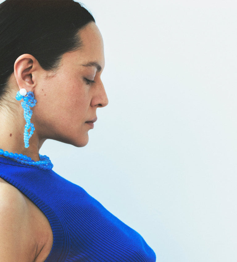 Woman wearing a blue top with a blurred background